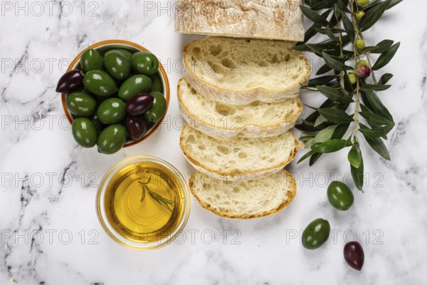 Appetizer, sliced ciabatta bread, with olive oil, green olives, Chalkidiki olives, classic Green