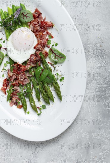 Asparagus with poached egg and fried bacon, micro greens and spices, breakfast, homemade, no people