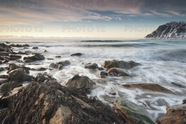 Long exposure, winter evening mood at Skagsanden, stones on the beach at Flakstad, Flakstadøy,