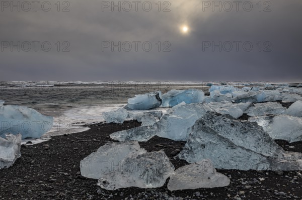 Ice floes on the beach, waves, sea, clouds, sunlight, winter, Diamond Beach, Breidamerkursandur,