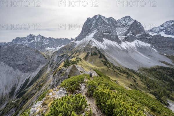 Mountaineers on a hiking trail on the ridge of Hahnkampl, mountain panorama with rocky steep peaks,