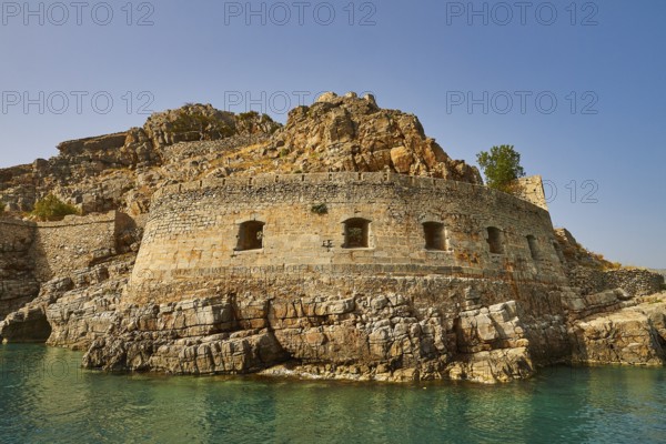 Ancient fortress on rocky coastal terrain with clear blue sea and sky, Venetian sea fortress, Leper