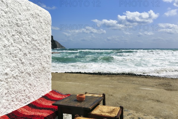 Simple wooden table with bench and stools outside, bar overlooking the sea, beach bar, Cabo de Gata