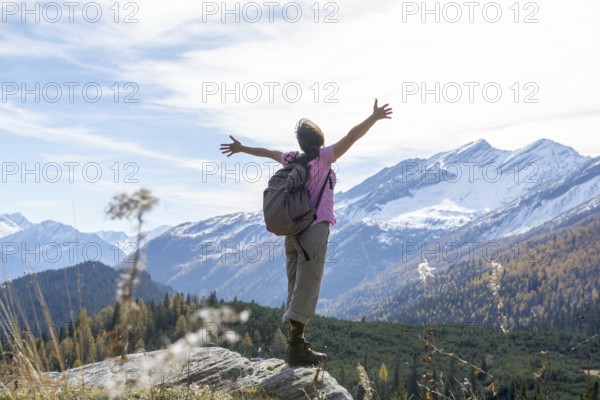 Woman Hiking and with Her Arms Outstretched and Enjoy Mountain Scape with Snow in San Bernardino,