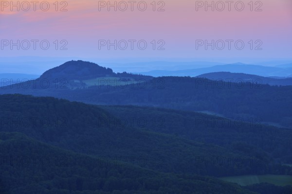 A calming mountain landscape at dusk with soft blue tones and a romantic horizon, Milseburg,