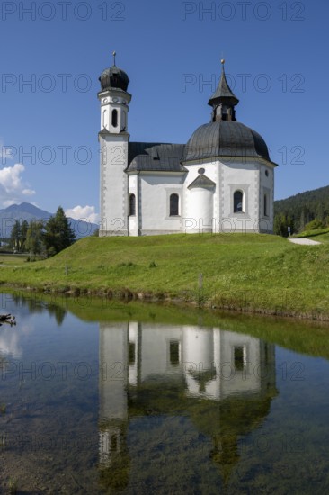 Seekirchl with reflection, Heiligkreuzkirche, Seefeld, Tyrol, Austria, Europe