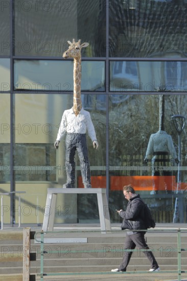 Modern building of the broadcasting station Arte of ARD and ZDF with sculpture giraffe man by