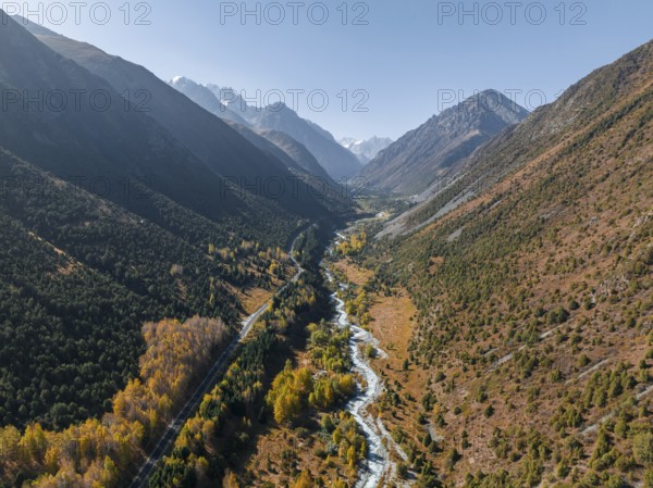Aerial view, mountain stream Ala Archa flows through the Ala Archa valley, autumnal mountain
