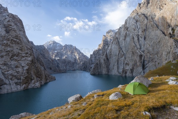 Wild camping, camping in the wilderness with a tent in front of mountain lake Kol Suu, Sary Beles