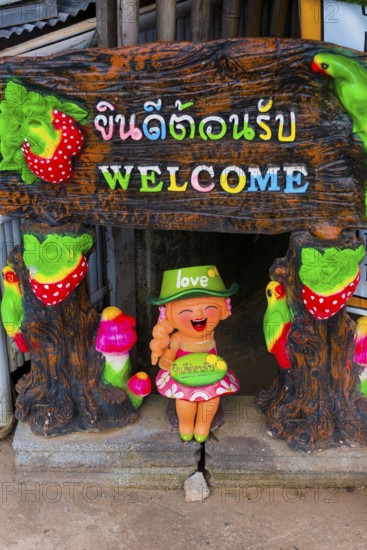 Welcome, sign in a hotel entrance, greeting, inviting, colourful, shrill, asian, friendly, hint,
