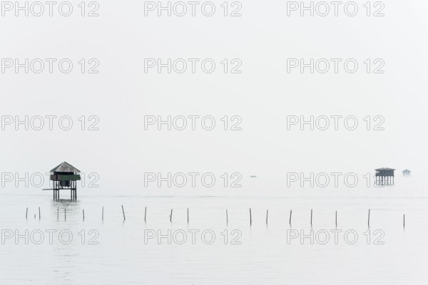 Traditional wooden huts of fishermen in the Gulf of Thailand in the morning haze, fisherman,