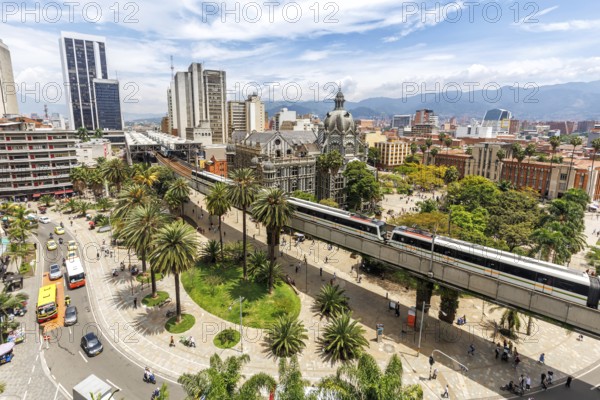 Medellin skyline with a train of the Metro de Medellín at Plaza Botero in Medellin, Colombia, South