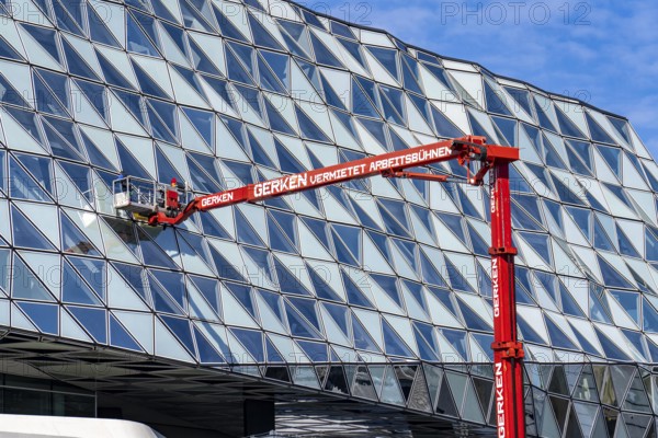 Building cleaners cleaning window panes, cleaning a facade, lorry working platform of the German