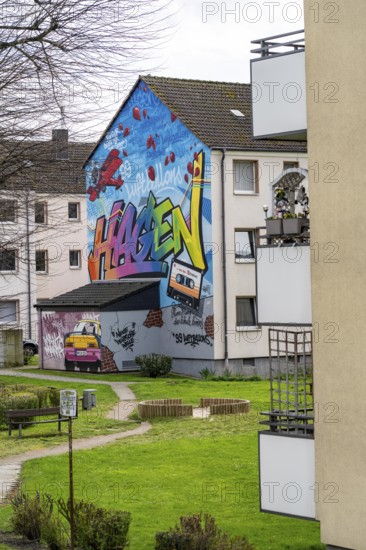 Housing estate, apartment buildings, colourful mural with local reference, music, 99 balloons, in