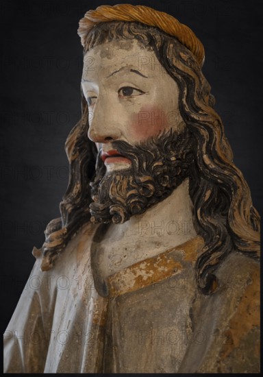 Palmesel, detail of Christ's head, wooden figure from 1470, on a dark background, Franciscan