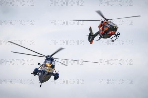 A Sea King MK41 multi-purpose helicopter and an H145 search and rescue helicopter, photographed as