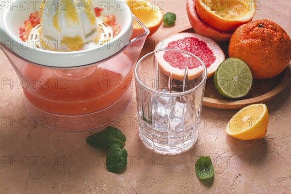 Citrus juicer, sliced fruit, glass with ice, close-up, no people, breakfast