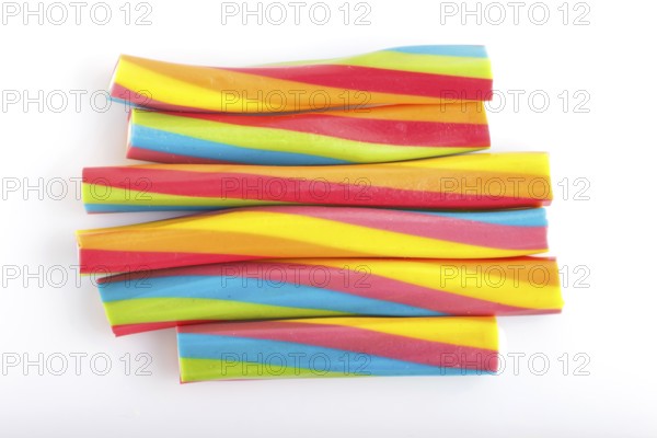 Rainbow chewing caramel sugar candies isolated on white background. top view
