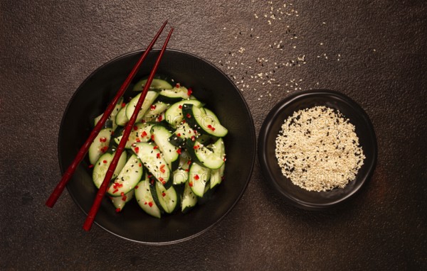 Chinese salad, cucumbers with chili pepper and sesame seeds, homemade, no people