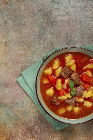 Meat goulash, with potatoes and carrots, sweet pepper, traditional Hungarian soup, homemade, no
