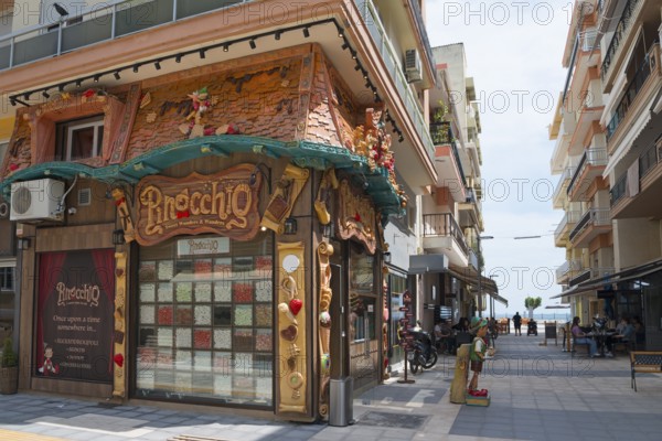 Exterior view of a shop with a unique fairy-tale style façade on a street, shop with sweets,