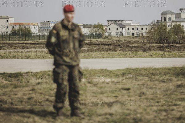 A soldier stands out in front of the training town, taken as part of a Bundeswehr exercise with