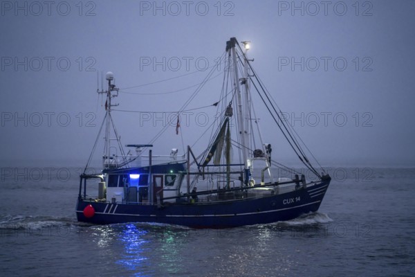 Thick fog in winter, hangs over the mouth of the Elbe into the North Sea, fishing boat, shrimp