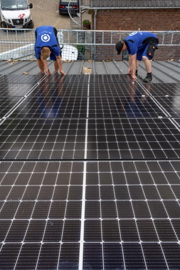 Installation of solar modules on the roof of a barn on a farm, over 240 photovoltaic modules are