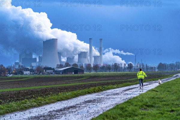 Field path, woman walking her dog, lignite-fired power plant, RWE Power AG Niederaußem power plant,