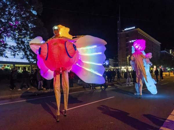 Walking act, underwater, stilt artists float gracefully across the festival as fish, octopus or