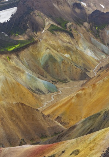 Small river between colourful rhyolite mountains, volcanic landscape, erosion landscape, view from