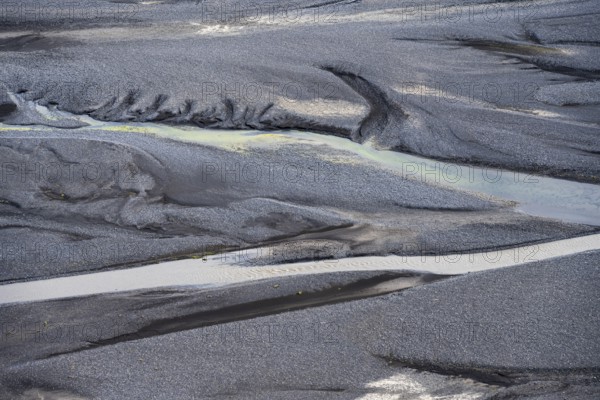 Detail, structure, river course in a gravel bed with black sand, meandering river, Dímonarhellir,