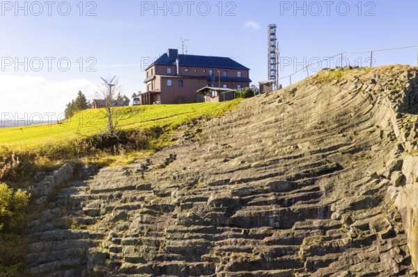 Basalt outcrop from a former quarry on the Hirstsein with mining hut, Erzgebirge, Marienberg