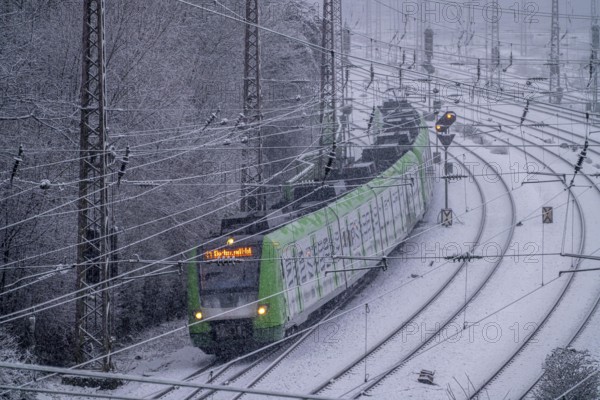 Winter weather, heavy snowfall, railway tracks in front of Essen main station, S-Bahn train, North