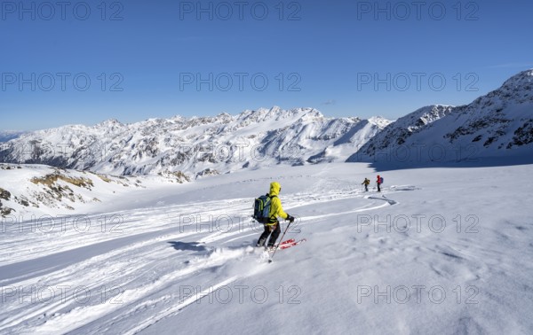 Ski tourers descending from the summit of Monte Cevedale on the Zufallferner, mountain panorama,