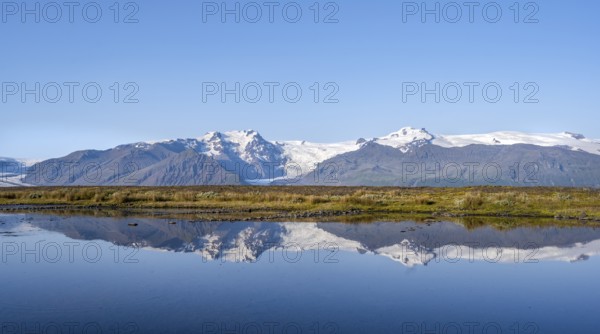 Lake with reflection, view of glacier tongues Skaftafellsjökull and Svínafellskökull, glaciated
