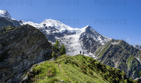 Mountaineer on a hiking trail in front of mountain landscape with glacier, view of glacier Glacier