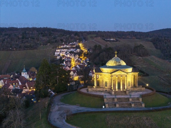 Burial chapel on the Württemberg at night on a hill with village lights, illuminated,