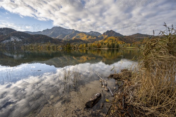 On the shore of Lake Lake Kochel with reflection, autumn landscape with mountain peaks Herzogstand