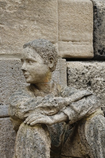Sculpture in front of the old school building, art in public space, stone figure, sculpture by the