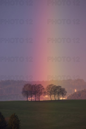 Rainbow touches a group of trees, Mühlviertel, Austria, Europe
