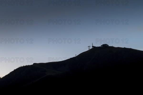 Silhouette of a mountain with cable car in the soft light of dawn, Saalbach Hinterglemm, Salzburg,
