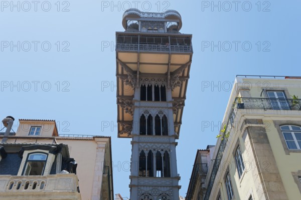 Historic Gothic style lift in Lisbon, rising between old buildings and standing out against a clear