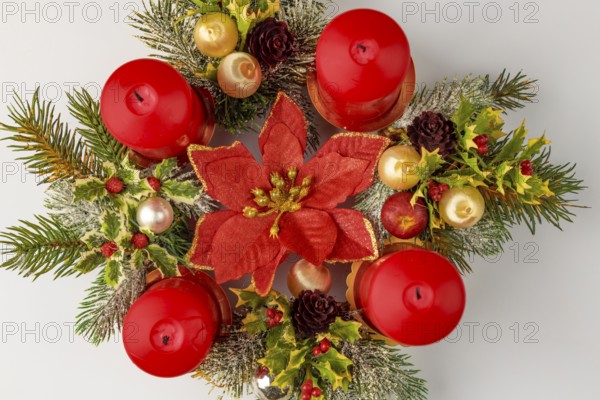Round Advent wreath with red candles and Christmas decorations, from above
