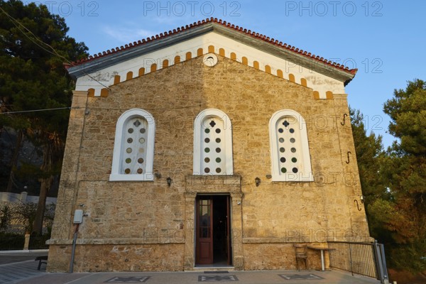 Historic church with striking stone façade and symmetrical windows, Koroni, Byzantine fortress,