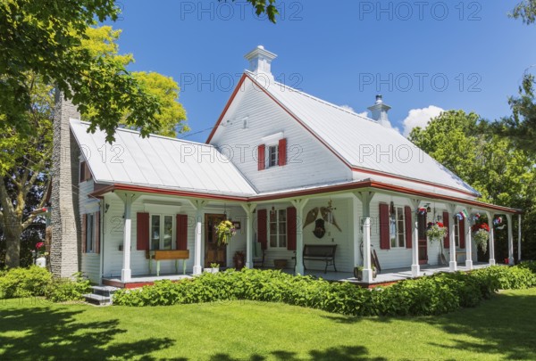 Old circa 1840 white horizontal wood plank with red trim Canadiana style house facade with silver