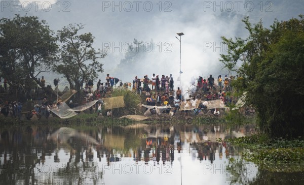 Villagers participate in a community fishing event on the occasion of the Bhogali Bihu festival at