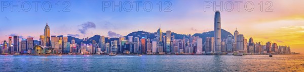 Panorama of Hong Kong skyline cityscape downtown skyscrapers over Victoria Harbour in the evening