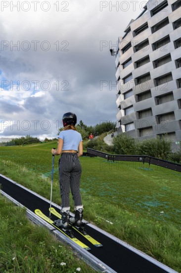 CopenHill, waste incineration plant and artificial ski slope, skiing with a view of the ski lift,