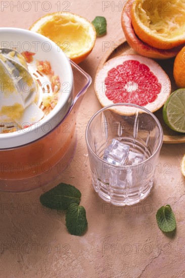 Citrus juicer, sliced fruit, glass with ice, close-up, no people, breakfast